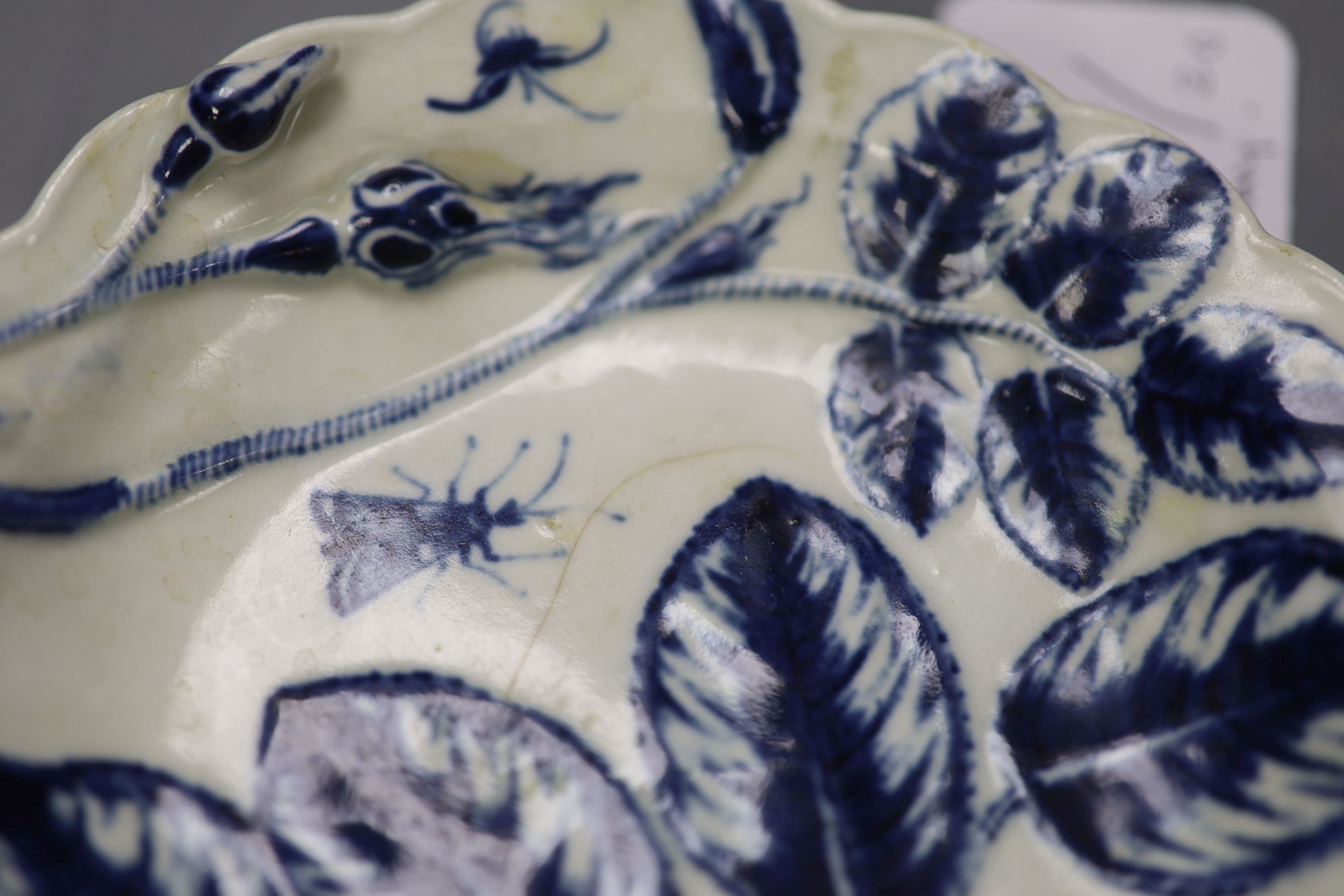 A Worcester small sauceboat painted with Two Porter Landscape in moulded panel, flowers verso, c.1760